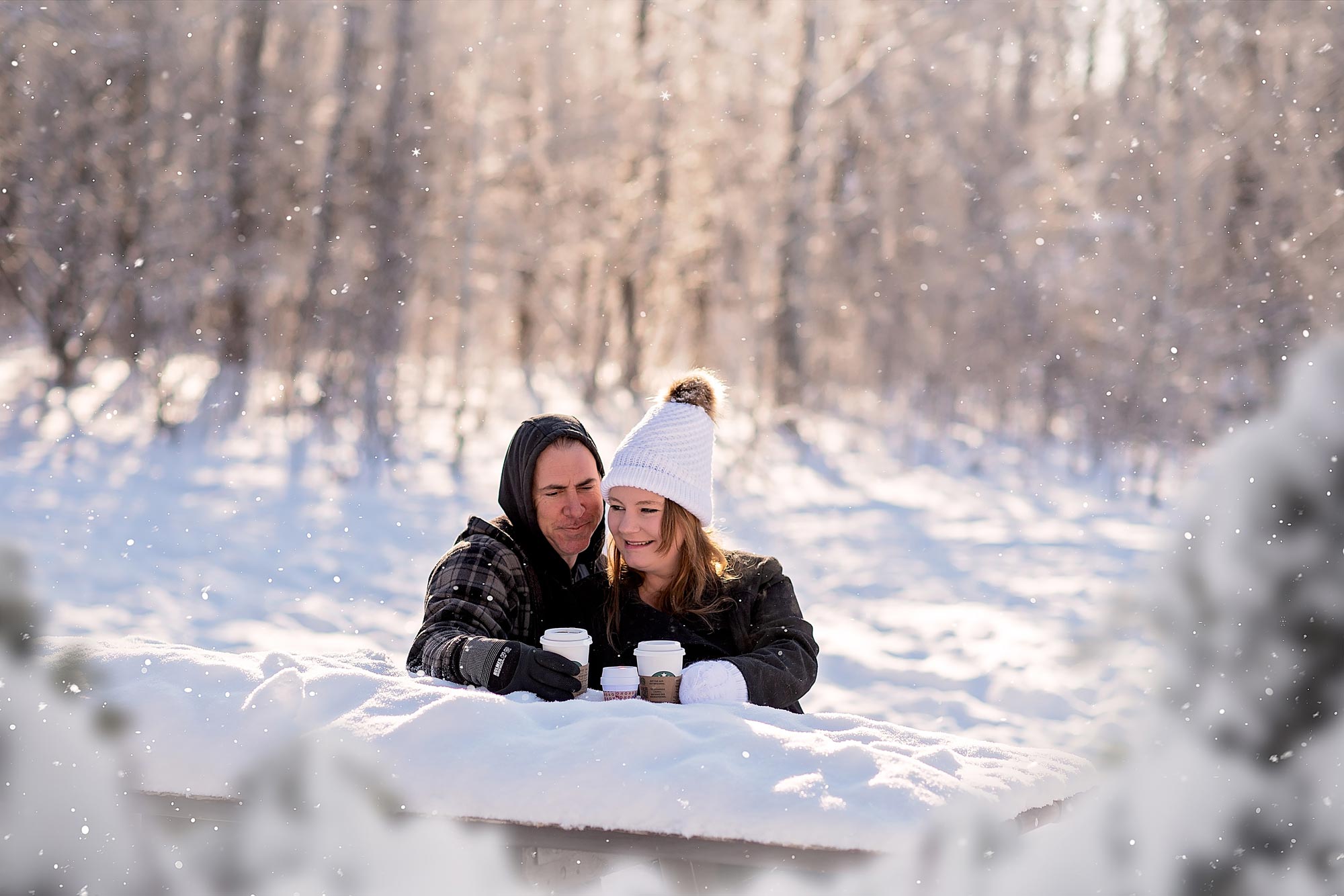 couple drinking coffee in the snow