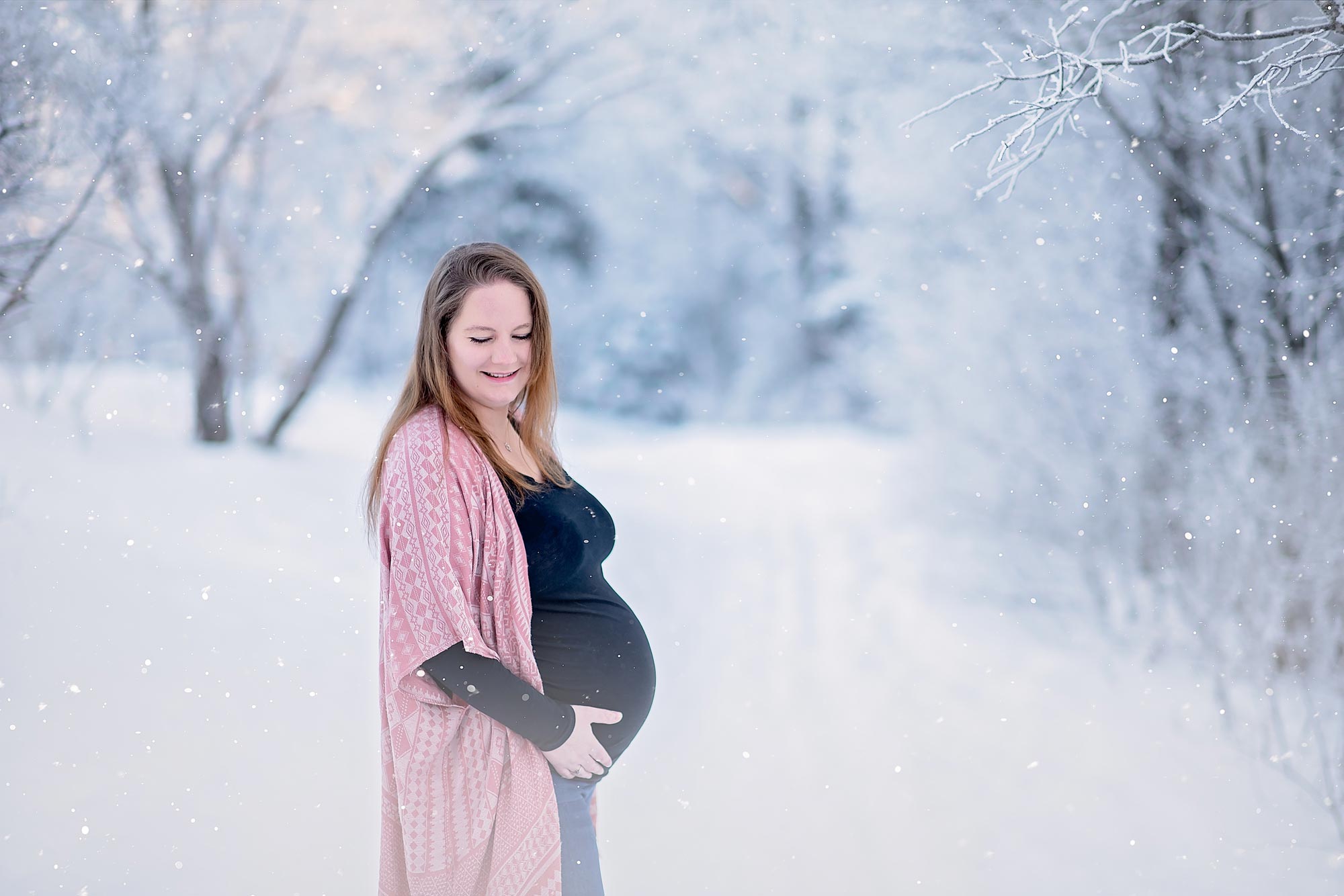 pregnant woman posing in the snow