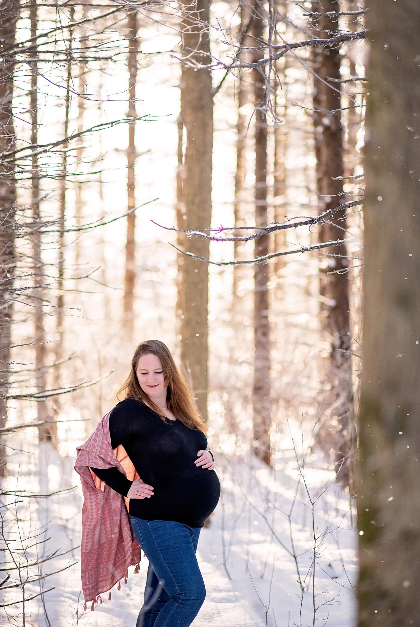 pregnant woman posing in the forest
